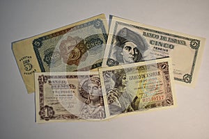 Cenital view of five and one peseta bills with white background photo