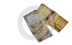 Cenital view of 5000 and 2000 indonesian rupiah bills with white background