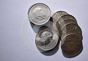 Cenital view of a pile of five peseta coins from 1949 and white background photo