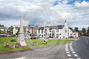 Cenotaph and local pub on the village green of Langwathby, Cumbria, UK