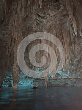 A cenote cavern in the Yucatan of Mexico with enormous stalagtites and stalagmites.