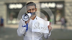 Censored male protester with megaphone.