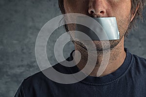 Censorship concept, man with duct tape on mouth photo