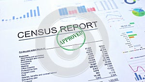 Census report approved, hand stamping seal on official document, statistics