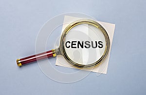 Census word through magnifier over blue background