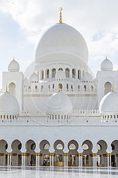 Center marble domes of Sheikh Zayed Grand Mosque with blue sky in the morning at Abu Dhabi, UAE