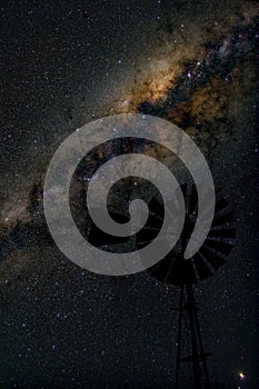 Center of Milky way galaxy with windmill in foreground