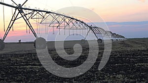 Center pivot irrigation at sunset 4