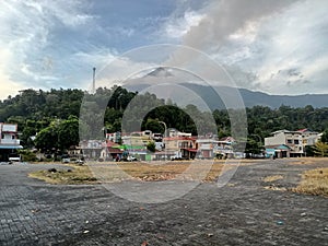 The center of Ulu city is fronted by views of the Karangetang volcano on Siau Island photo