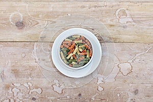 Centered bowl of multicolored rotini pasta