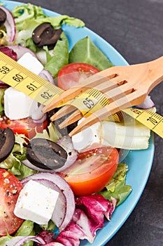 Centimeter and greek salad with feta cheese and vegetables. Slimming, healthy lifestyles and nutrition