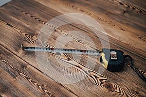 centimeter tape on wooden table background image hammer top view