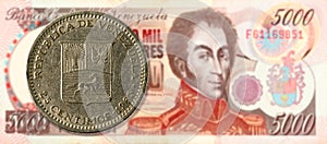 25 centimos coin against 5000 venezuelan bolivar bank note photo