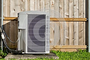 Central air conditioning unit in a residential backyard.