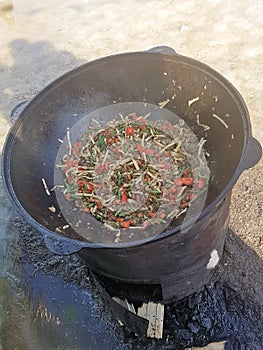 Central asian cuisine - top view of hot cooked pottage from lamb and vegetables in cast iron cauldron