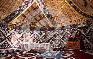 Central Asian yurt interior with traditional felt carpets and furniture photo