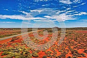 Central Australia aerial view with view of road and orange landscape