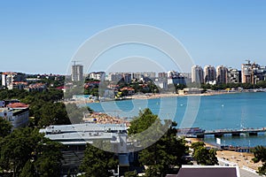 The Central beach of Gelendzhik resort with numerous sunbathers on the sand. Urban landscape.