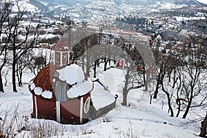 Central church of calvary in Banska Stiavnica covered with snow, view from upper chapels path during winter 2018