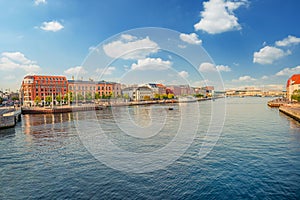 The central city with many houses and a river canal with ships. Copenhagen, Denmark