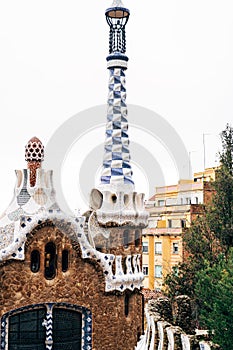 The central entrance to The Park Guell in Barcelona. Gingerbread houses. Right house with a long tower