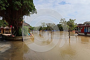 Central flooded street in Hoi An, Vietnam along the Thu Bon River during the 2021 rainy season