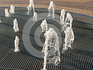 Central fountain. Jets of water rise up and scatter into small drops. Close-up. Noyabrsk, Russia