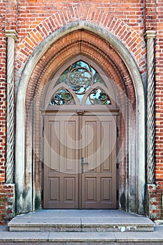 The central front door to the old public medieval brick church