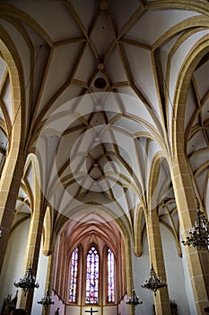 Central nave with beautiful ribs and three slender windows behind the altar of a parish church in Graz.