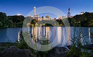 Central Park Lake at twilight with skyscrapers. New York City