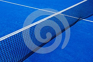 Central part of a paddle tennis court and the net