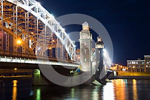 The central part of Peter the Great Bridge close up in night illumination. St. Petersburg, Russia