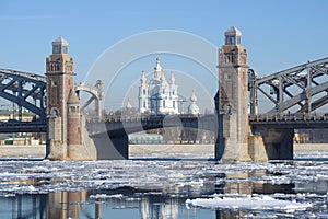The central part of Peter the Great bridge and the Smolny Cathedral during the spring ice drift. Saint-Petersburg