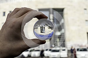 Central postal office of naples view in a glass ball