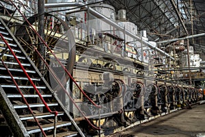 Central shaft driving by belt other machines in old factory, Java, Indonesia