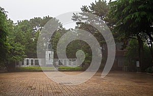 Central Square with Statue of Choe Chiwon and Pavilion in Dongbaek Park on a foggy day. Haeundae-gu, Busan, South Korea. Asia
