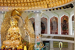 The Centre of Buddhism in Sanya. Temple with Lotus on the ceiling, Golden Buddha and many statues and goddesses.