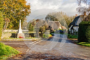 The centre of the village of Tarrant Monkton in Dorset, England UK, showing the war memorial .