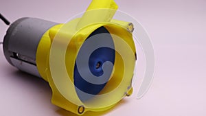 Centrifugal water pump with visible impeller. DC Motor powered centrifugal water pump working with disassembled case. Water pump