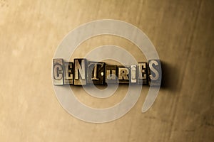 CENTURIES - close-up of grungy vintage typeset word on metal backdrop