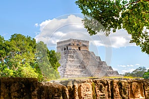 Chichen Itza Pyramid of Kuklukan With Tzompantli or Wall of Skulls in Foreground photo