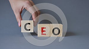 CEO - Chief executive officer symbol. Concept word CEO on wooden cubes. Businessman hand. Beautiful grey background. Business and
