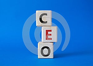 CEO - hief executive officer symbol. Concept word CEO on wooden cubes. Beautiful blue background. Business and CEO concept. Copy