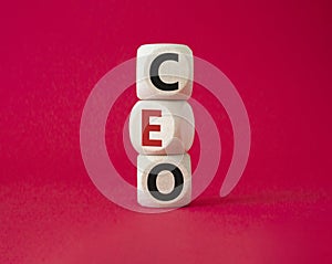 CEO - hief executive officer symbol. Concept word CEO on wooden cubes. Beautiful red background. Business and CEO concept. Copy