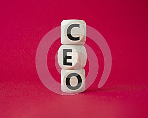 CEO - hief executive officer symbol. Concept word CEO on wooden cubes. Beautiful red background. Business and CEO concept. Copy