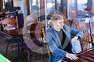 CEO with smartwatch waiting order in cafe and thinking about new