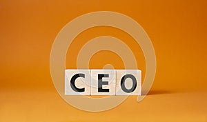 CEO symbol. Concept word CEO on wooden cubes. Beautiful orange background. Business and CEO concept. Copy space