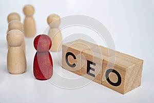 CEO text on wooden blocks with wooden figure representing leader. Leadership concept