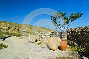 Ceramic ancient amphora for wine on a background of mountains outdoors