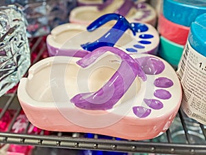 Ceramic ashtray in the shape of a flip flop. Vacation Concept